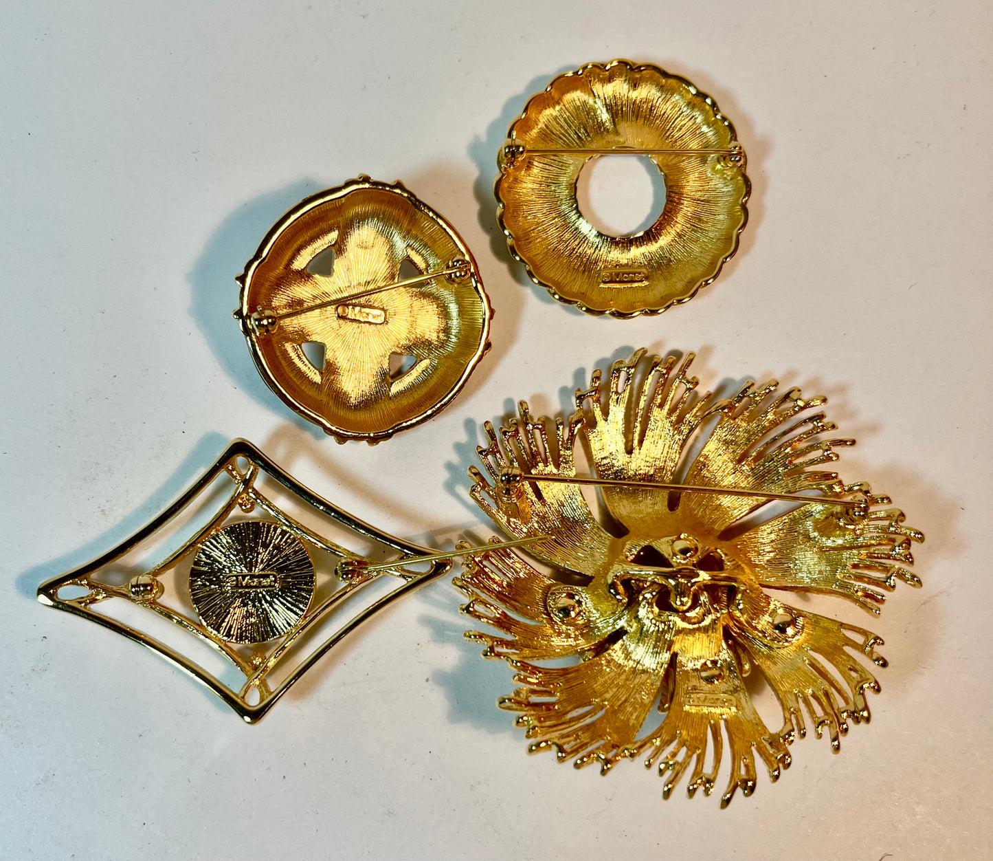 Four Monet Brooches